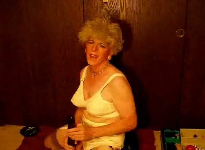 Video: Old amateur transsexual Joanne Slam smoking while she models her dick in this home movie